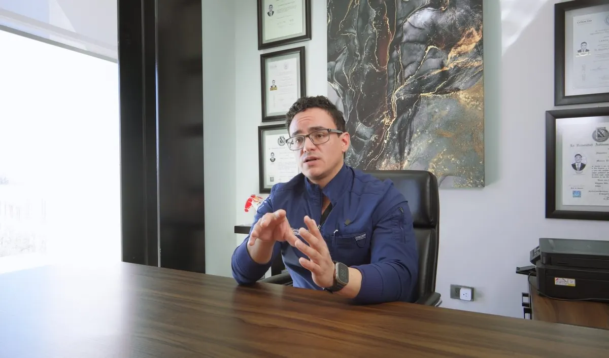 El Dr. Alejandro Alarcón en su consultorio en Chihuahua, con sus diplomas de especialidad al fondo