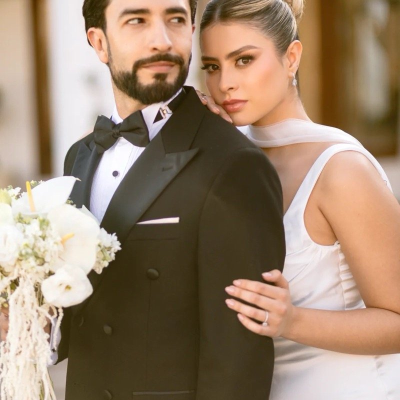 Groom in a tuxedo rented from Filli's